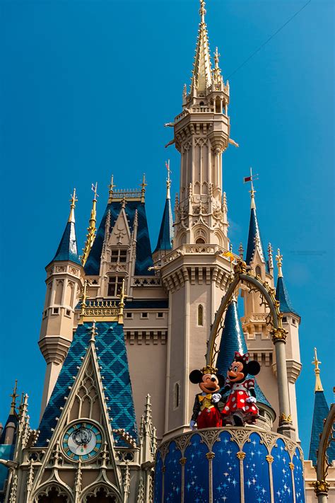 Mickey Mouse and Minnie Mouse perform in front of the Cinderella Castle ...