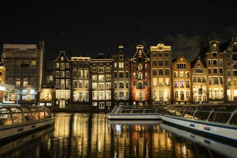 The Main Street of Damrak Amsterdam the Netherlands with Dancing Houses ...