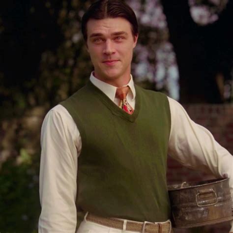 a man wearing a green vest and tie