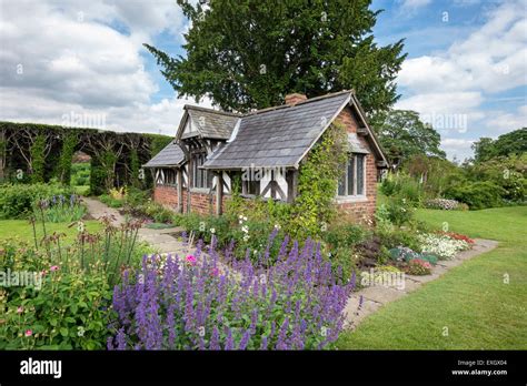 Quaint cottage surrounded by flowers at Arley Hall gardens in Cheshire ...