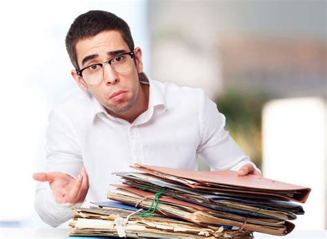 Free Photo | Man with pitying face with a mountain of folders