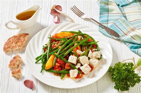 Premium Photo | Fasolakia lathera green beans onion and potatoes stewed in tomato herbs and ...