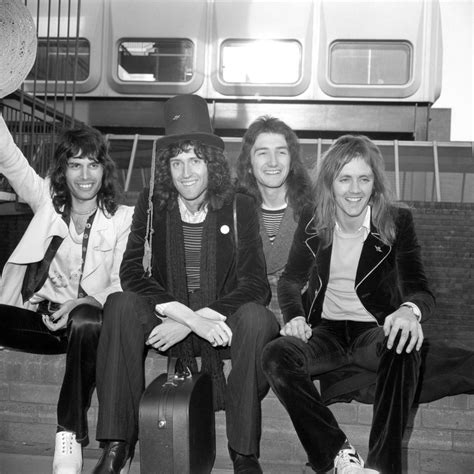 The four members of the rock band 'Queen' arrive back from their tour ...