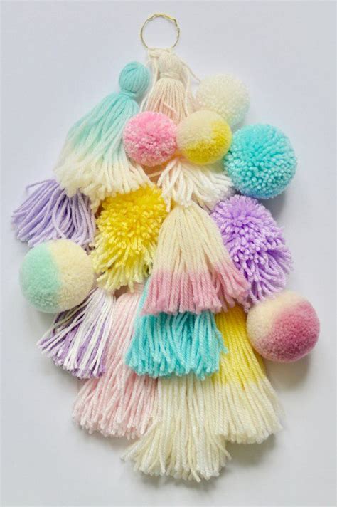 Handmade colorful yarn tassel and pompom wall hanging, embellished with dip-dyed tassels and ...