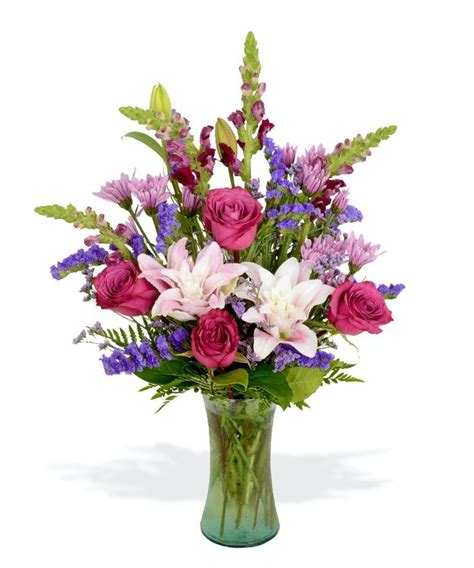 a vase filled with lots of purple and white flowers