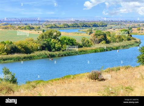 View of the Southern Bug River and the railway bridge on the horizon Stock Photo - Alamy