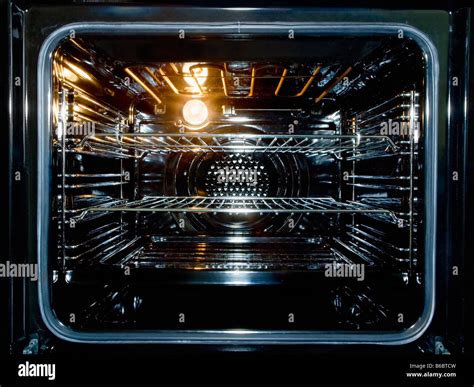 The inside of a new electric oven with the light on Stock Photo - Alamy