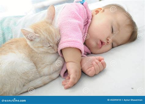 Baby And Cat Sleeping Together Stock Photo - Image: 45209418