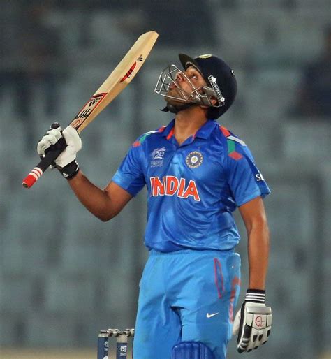 Rohit Sharma raises his bat after reaching a half-century | ESPNcricinfo.com