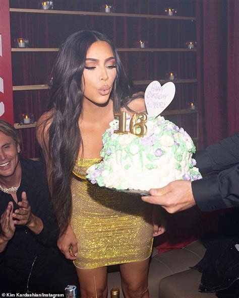 Kim Kardashian blows out the candles to her sweet sixteen cake as she ...