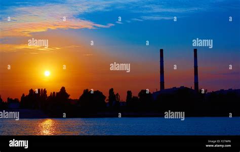 factory in silhouette and sunrise sky Stock Photo - Alamy