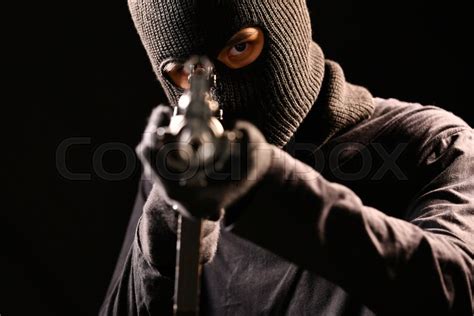 The Robber aiming rifle on black ... | Stock image | Colourbox