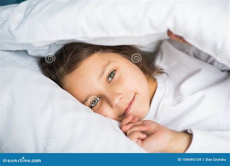 Pretty Little Girl in Sleepwear Lying Under Blanket in the Bed at Home Stock Photo - Image of ...