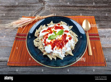 Plates of traditional Turkish food. Turkish Ravioli (Mantı) with yoghurt and tomato sauce Stock ...