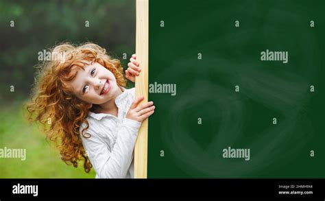 Laughing child with school blackboard showing healthy white teeth Stock Photo - Alamy