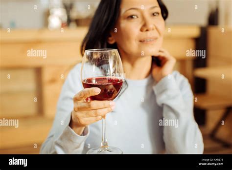 Thoughtful woman drinking red wine Stock Photo - Alamy