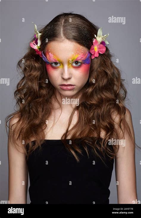Portrait of teen girl with orchid flower in wavy hair Stock Photo - Alamy