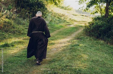 a Catholic monk in robes praying in the woods. Copy space Stock Photo ...