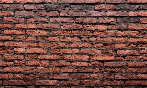 Premium Photo | A brick wall with a dark red brick background