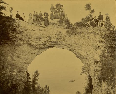 Historic photo shows Mackinac Island residents posing on Arch Rock