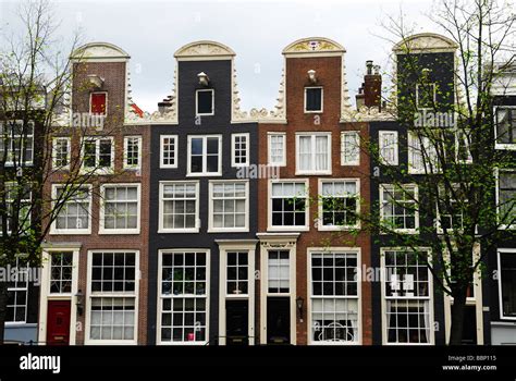 Typical Dutch houses along the canal in Amsterdam The Netherlands Stock Photo - Alamy