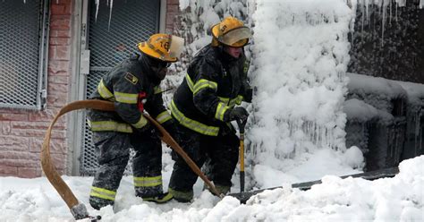 Incredible footage shows firefighters battling blaze in burning building with ICICLES hanging ...