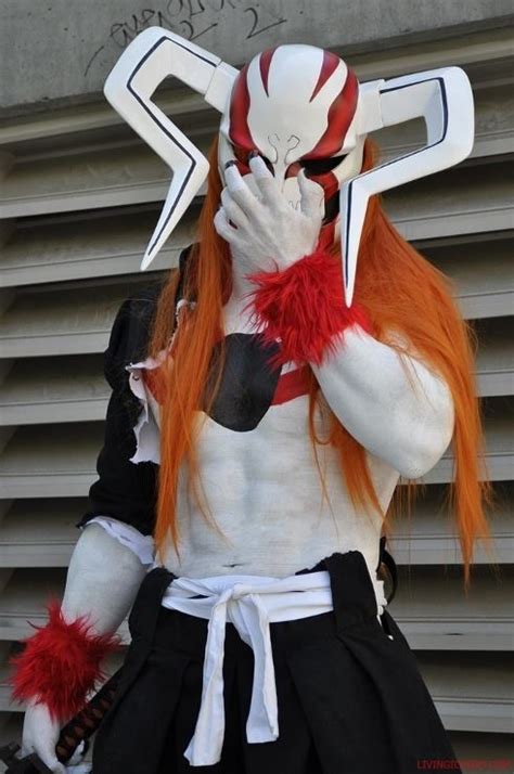 a person with long red hair wearing a costume and holding their hands ...