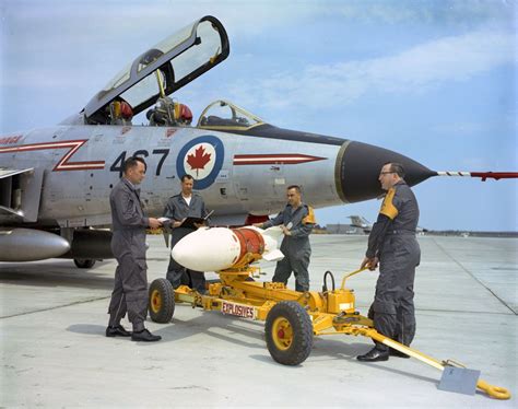 Load Crew practice loading a Dummy Genie Nuclear missile on to a CF101, mid- 60's RCAF Chatham ...