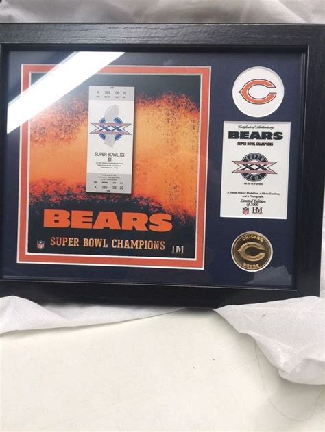 a framed chicago bears super bowl champs ticket and coin display with ...