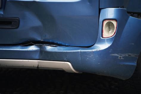 Premium Photo | A car with a dented bumper has been damaged in road ...