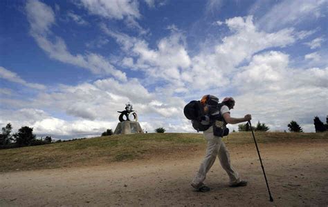 A pilgrim walks the Way of St. James outside Santiago de Compostela, northwestern Spain, on July ...