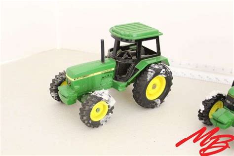 (2) John Deere Tractors 1/32nd - Musser Bros Inc