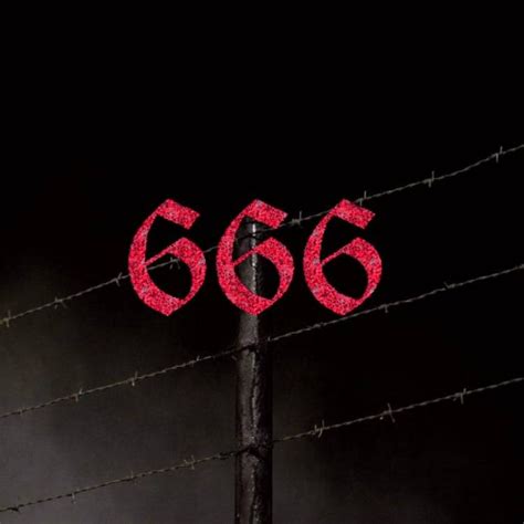 the number 666 is painted red on top of a barbed wire fence at night