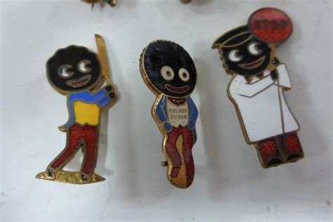 Six vintage Golly badges.