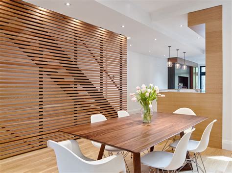The wood slat feature wall acts as a grounding element in the middle of ...