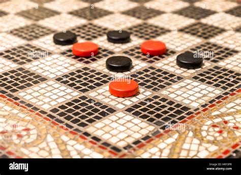 Black and red checkers on a black and white board made of small pieces of stone Stock Photo - Alamy