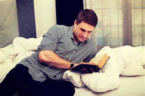 Man reading a book in his bed. — Stock Photo © piotr_marcinski #113894268