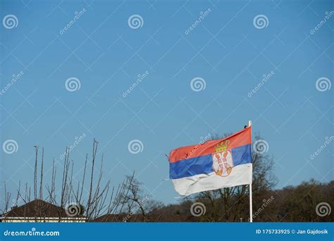 Serbian Flag Damaged by Wind and Weather and Slighltly Faded Colors Stock Image - Image of ...