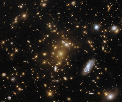 Hubble Captures a Light-Bending Galaxy Cluster - NASA Science