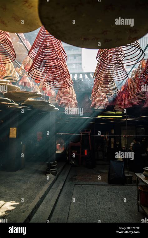 Hong Kong, Yau Ma Tei, Tin Hau Temple, incense spirals in light beam ...