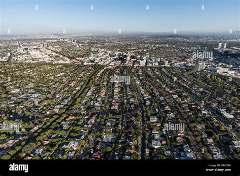 Afternoon aerial view of Beverly Hills streets with mid Wilshire and ...