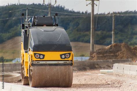 Road roller working on the new road construction site. Construction ...