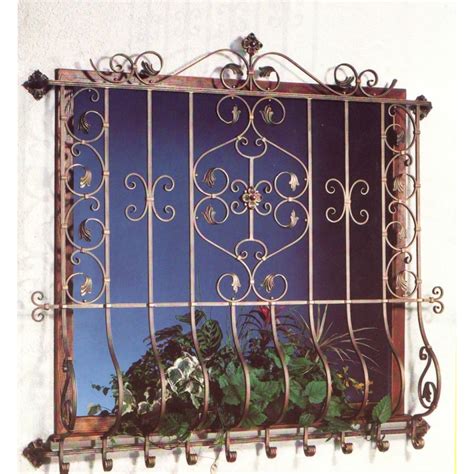 A decorative safety window grill made out of wrought iron