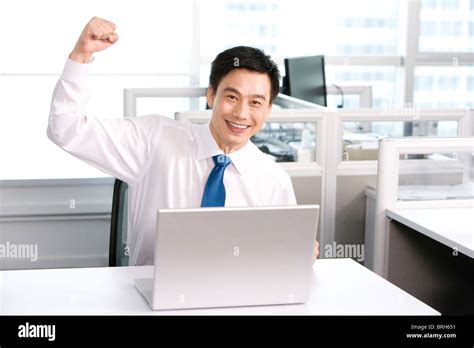 Happy office worker at his desk Stock Photo - Alamy