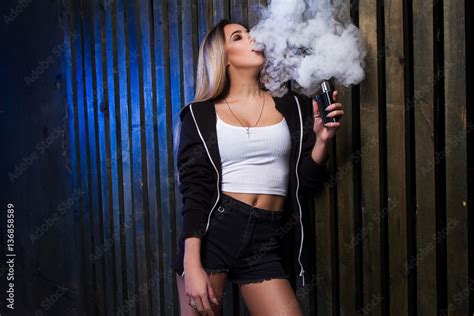 Portrait of sexy young vaping girl. Girl blowing vape. Vapor concept ...