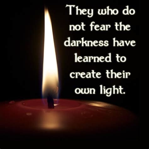 a candle with a quote on it that says they who do not fear the darkness ...