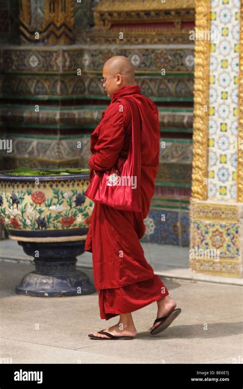 Buddhist monk wearing red robes, Royal Temple of Wat Phra Kaeo, Bangkok ...