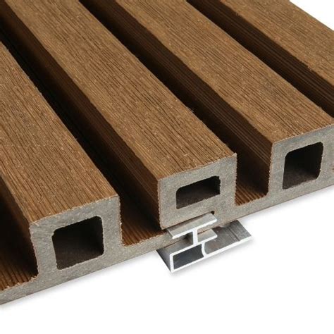 a close up view of some wood planks on a white surface with metal brackets