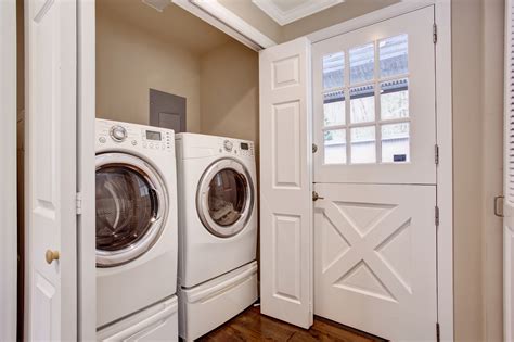 Small laundry area with washer and dryer. - Property Manager Insider