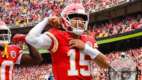 smiley patrick mahomes showing arm wearing red sports dress in crowd background hd sports ...